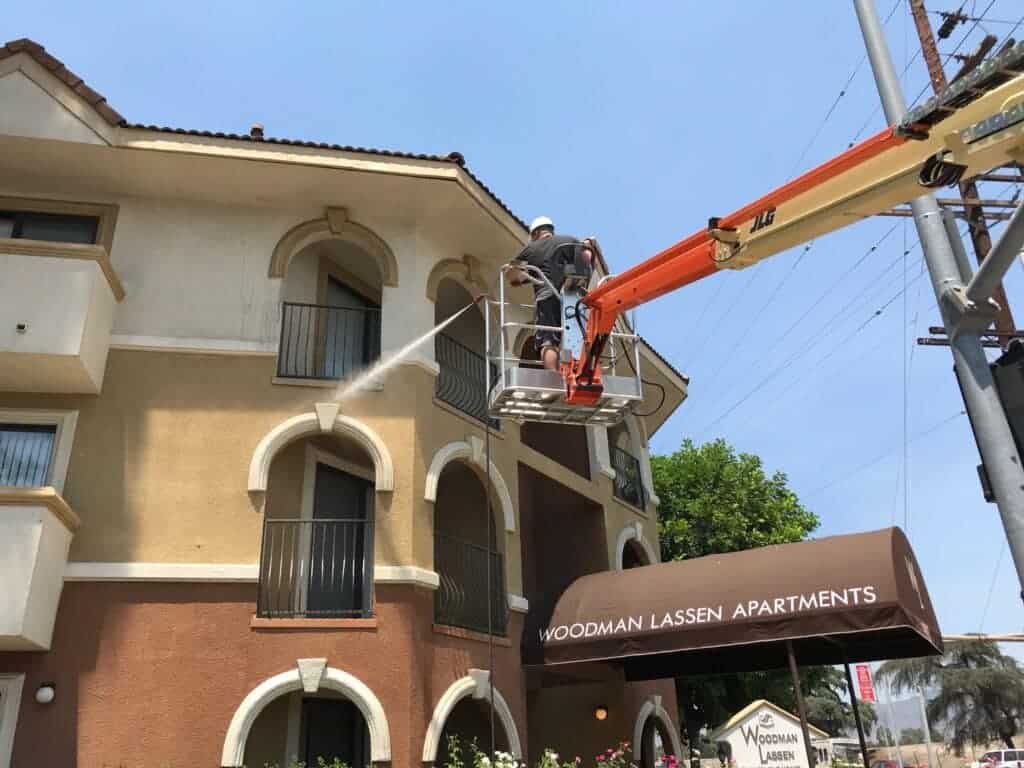 Pressure washing the exterior of an apartment complex