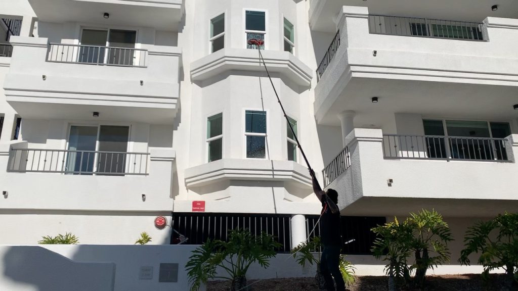 apartment complex window washing with an extended pole