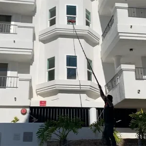 Window cleaning the second story of an apartment complex
