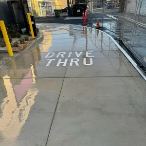 Water on a drive thru pavement after a power wash