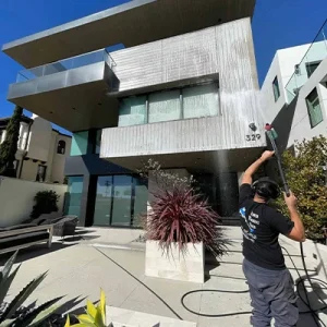 Washing the siding of a mansion in southern california