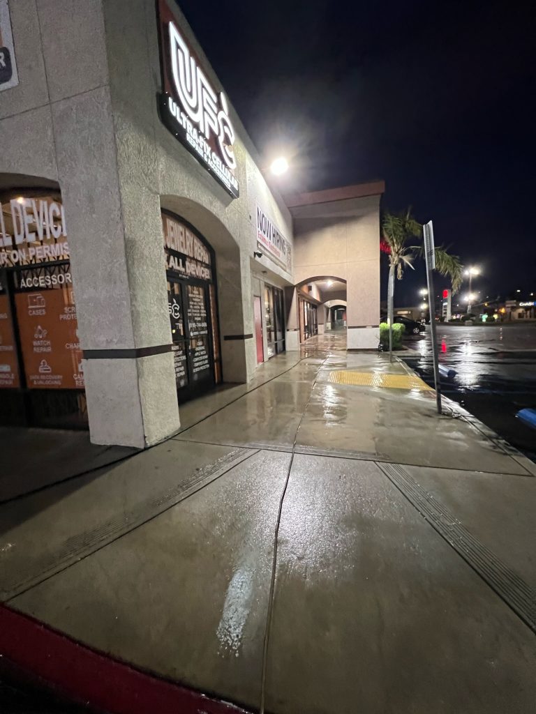 wet pavement in a shopping center after a power wash on the concrete sidewalk