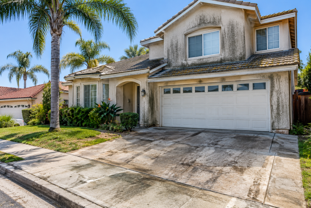 Los Angeles property showing dirty sidewalks, stained driveway, and exterior walls before professional pressure washing